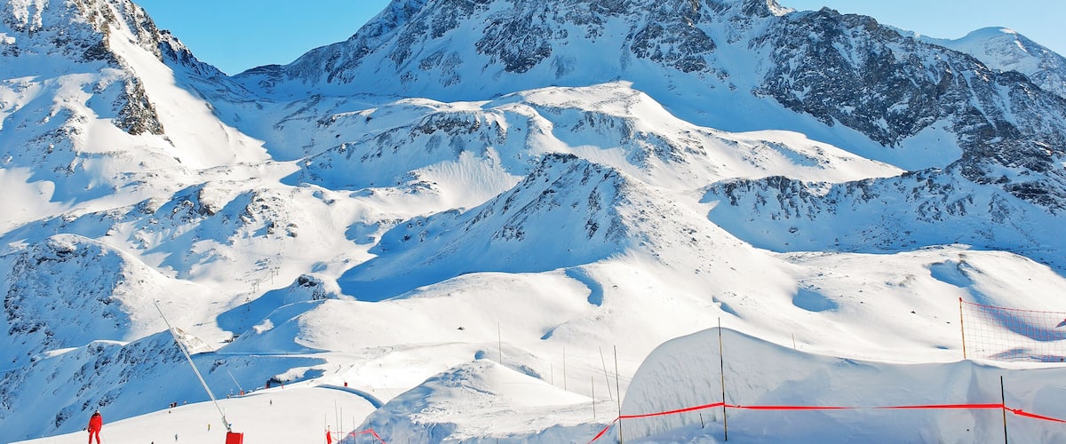 A snow-covered mountain with ski slopes and a ski lift.