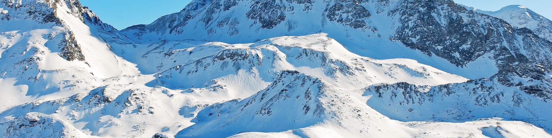 A snow-covered mountain with ski slopes and a ski lift.
