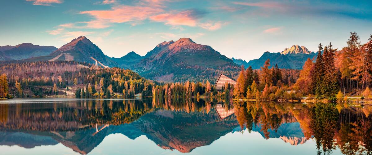 Panoramic autumn view of Strbske pleso lake. Calm morning scene of High Tatras National Park, Slovakia, Europe. Beauty of nature concept background.