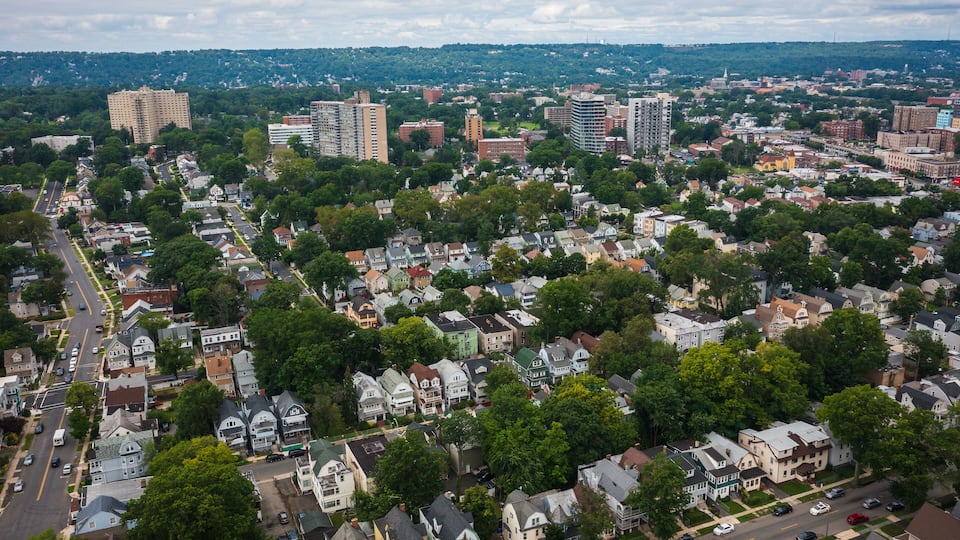 An aerial view of a densely populated urban area with residential houses, streets, and various buildings.