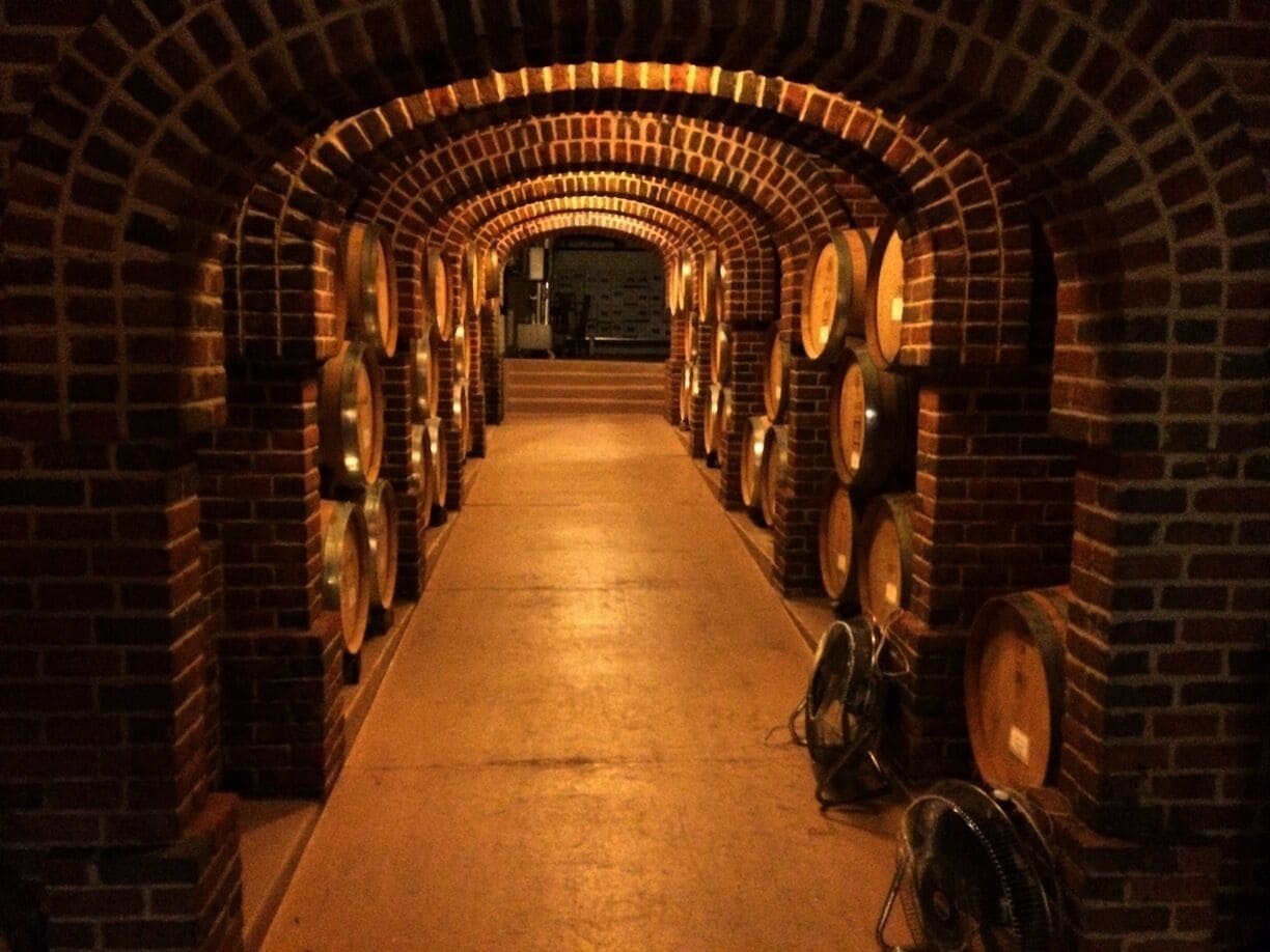 Barrels of wine line the walls of this underground tunnel displayed on the Lynfred Winery tour, the largest and oldest winery in Illinois.