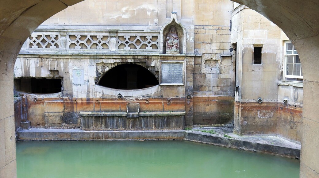 The Master of the Baths chair was donated in the 17th century, when the water level was higher (notice the orange stain line). Above the chair sits a statue of King Bladud, the mythical discoverer of the hot springs and founder of the City of Bath.
The Kings Bath itself dates from the 12th century. It was constructed above the Roman reservoir, using the original Roman walls and oak pilings for support (those pilings are still doing their job 2000 years later).