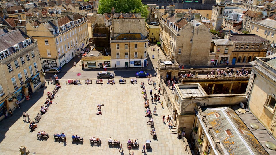 A square plaza surrounded by historic buildings with a central fountain.