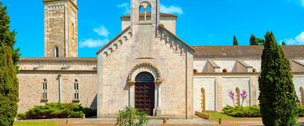 A historic church with a bell tower and arched windows.