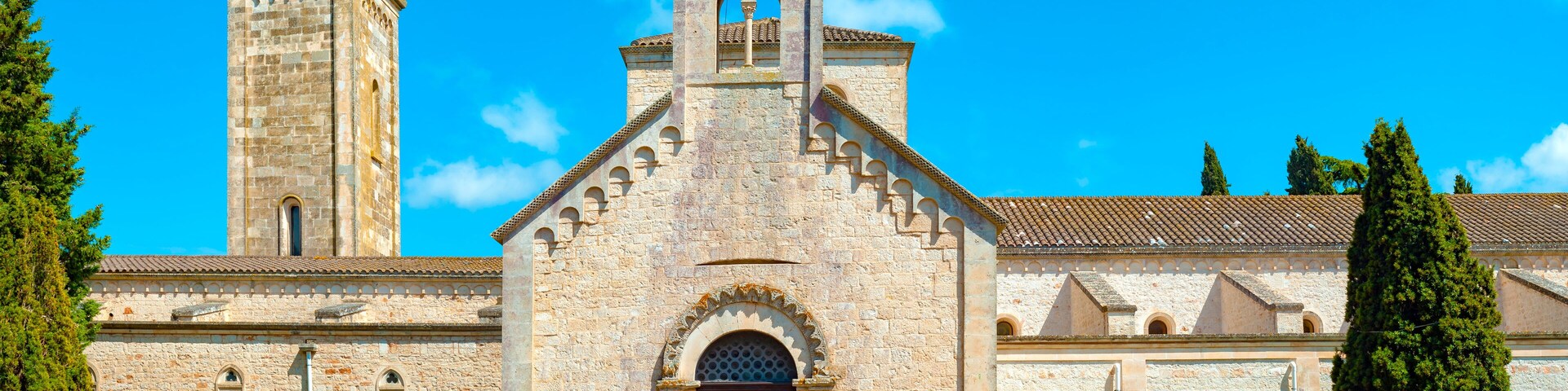 A historic church with a bell tower and arched windows.