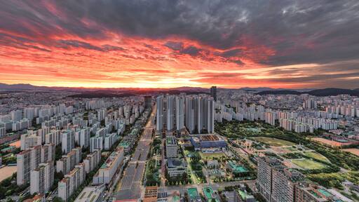 Wonmi-gu, Bucheon-si, Gyeonggi-do, South Korea - September 27, 2021: Aerial and panoramic view of Bucheon City Hall and high-rise apartments with Bucheon Central Park at sunrise