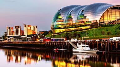 Famous Millennium bridge at sunset. Illuminated landmarks with river Tyne in Newcastle, UK