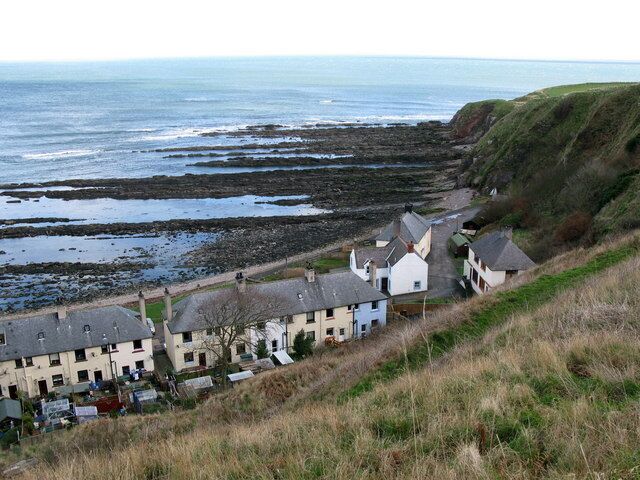 A coastal village with houses on a hillside overlooking the sea.