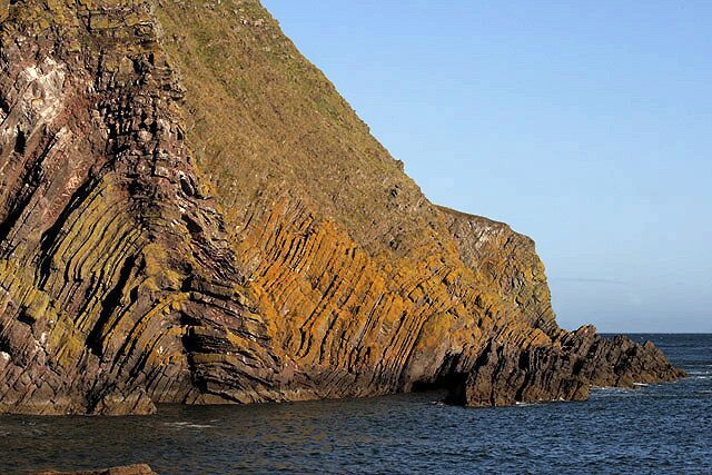 Cliffs at Hurker's Haven Access to the shore at this small inlet is possible by a steep grassy descent from the Berwickshire Coast Path. Good views can be had of the folded rocks on the cliffs.