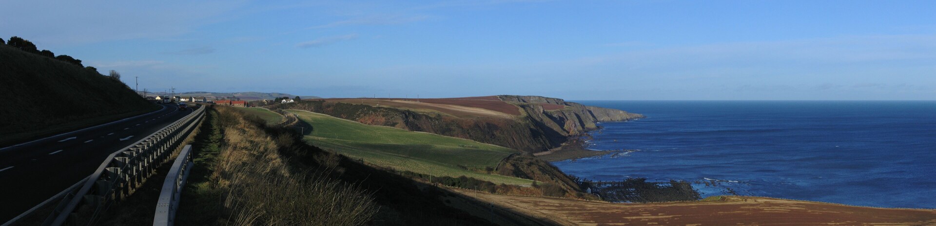 Coast in Scotland south of Burnmouth, where the East Coast Main Line and the A1 road pass close to the North Sea. Panoramic image created with hugin and enblend.