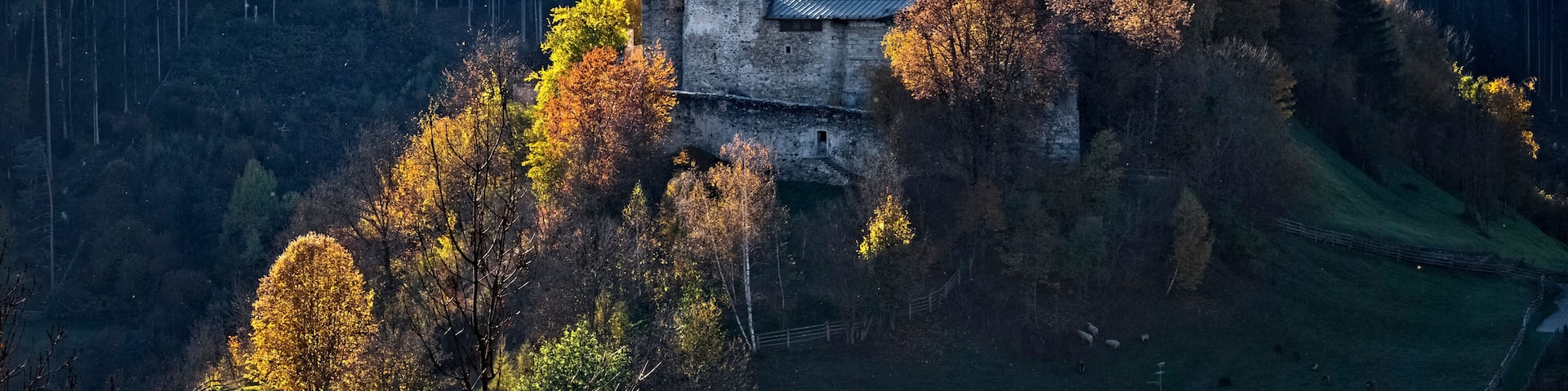 The medieval Badia Castle (Sonnenburg) and its rural area in autumn. San Lorenzo di Sebato / St. Lorenzen, Pusteria Valley, Bolzano province, Trentino Alto-Adige, Italy, Europe.