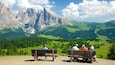 Alpe di Siusi featuring landscape views and tranquil scenes as well as a small group of people