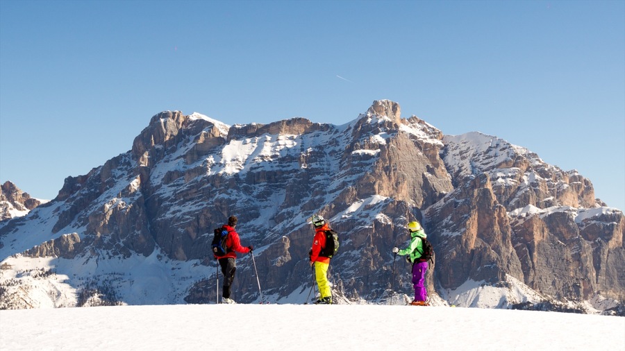 Alta Badia featuring snow and mountains as well as a small group of people