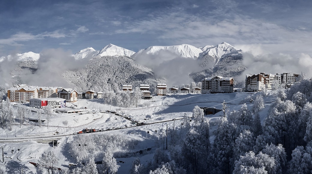 Panoramic view of the mountains and the village of Krasnaya Polyana. Aerial photography with copter. Esto-Sadok. Sochi. ski resort. Nature, snow, skiing, snowboarding