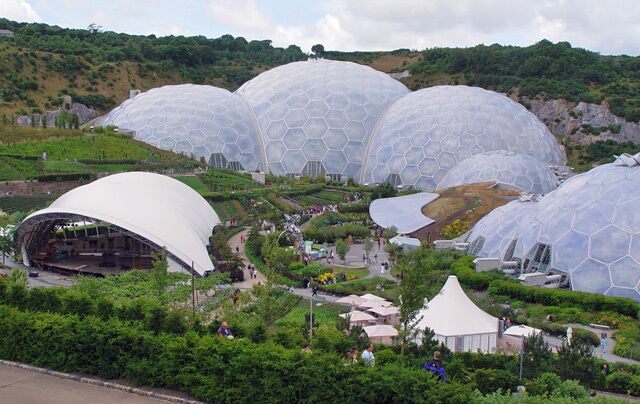 Large geodesic domes, a white dome, and a green landscape.