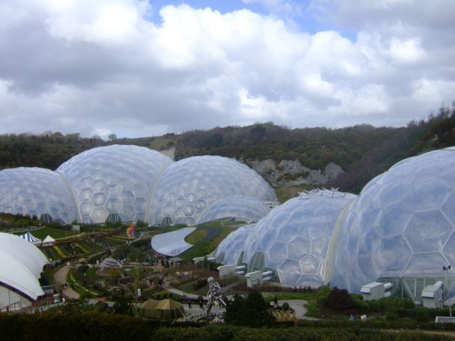 Large geodesic domes, a landscaped garden, and a hilly background.