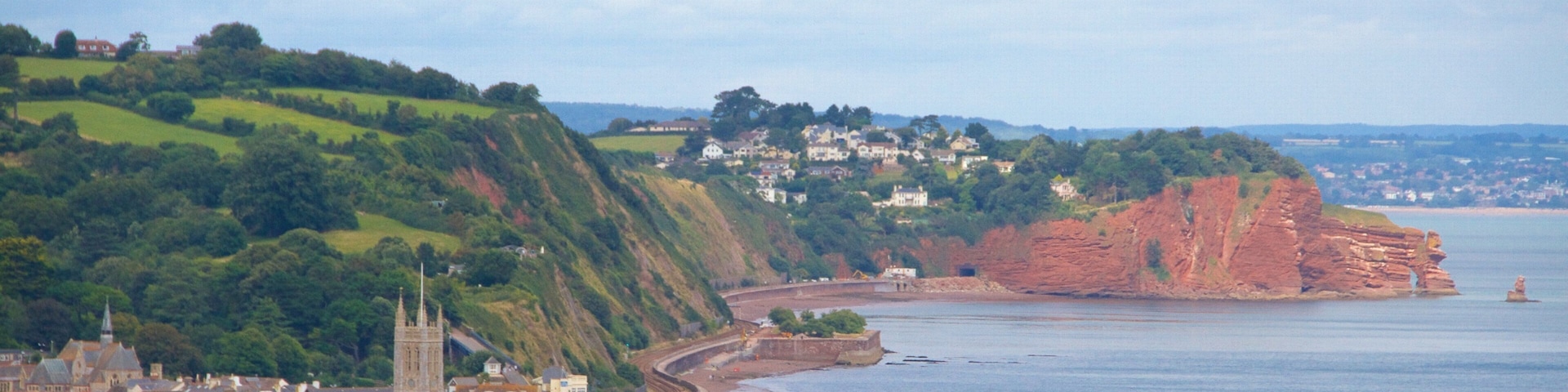 Teignmouth showing a bridge, a beach and general coastal views