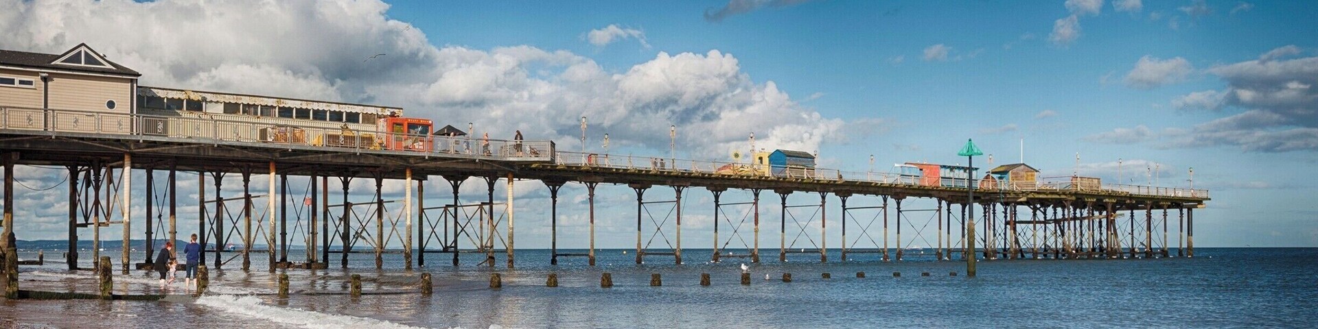 Teignmouth Pier, a long seafront well worth a walk and a pier with good old fashioned amusements too.