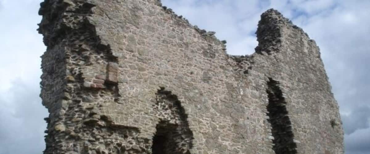 A tall, crumbling stone tower with arched openings.