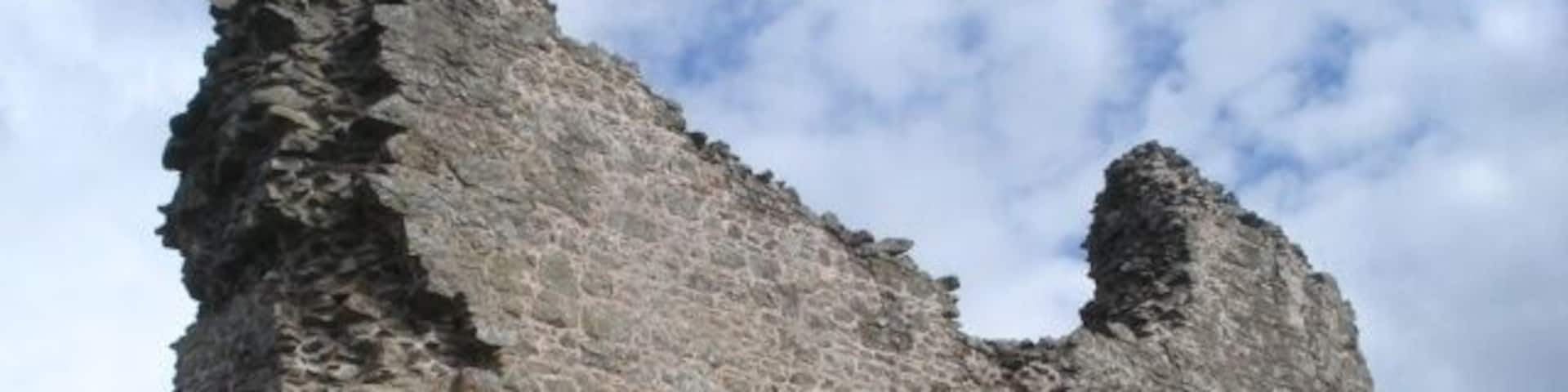 A tall, crumbling stone tower with arched openings.