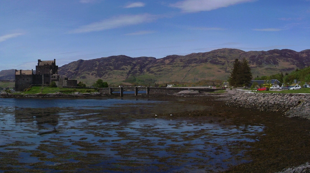 Eilean Donan Castle in Loch Duich, with the Isle of Skye visible in the distance. three photos stitched together using hugin, nona and enblend.
