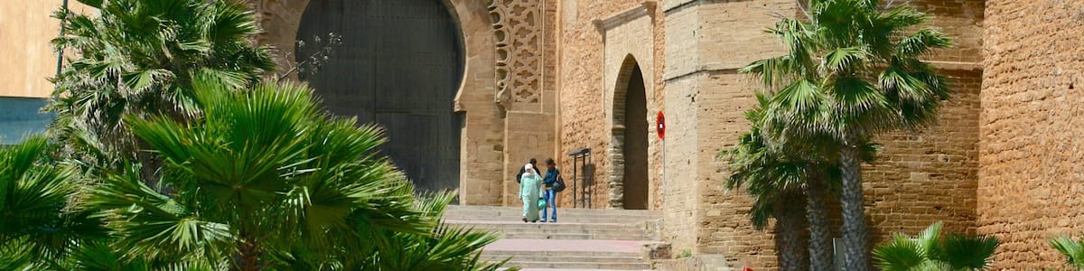 A historic building with intricate carvings and a large arched entrance.