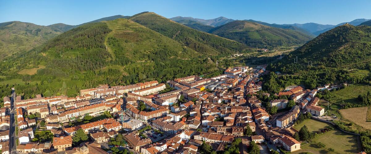 A town nestled in a valley surrounded by mountains.
