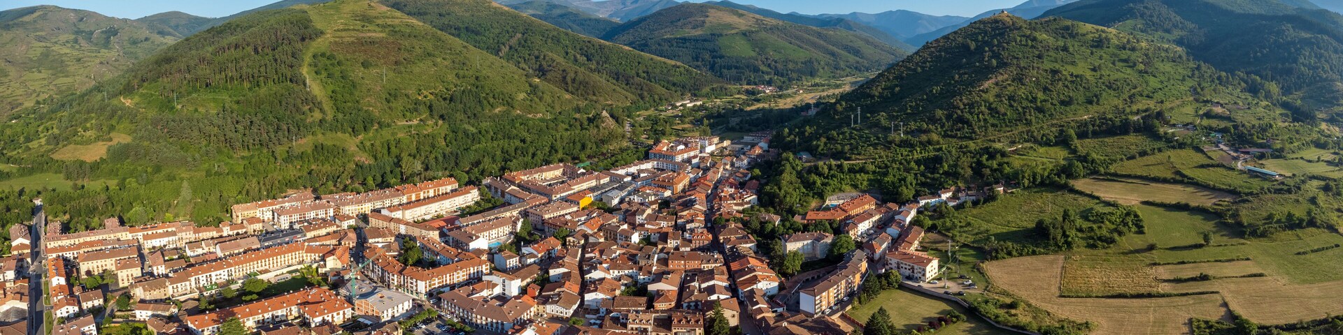 A town nestled in a valley surrounded by mountains.