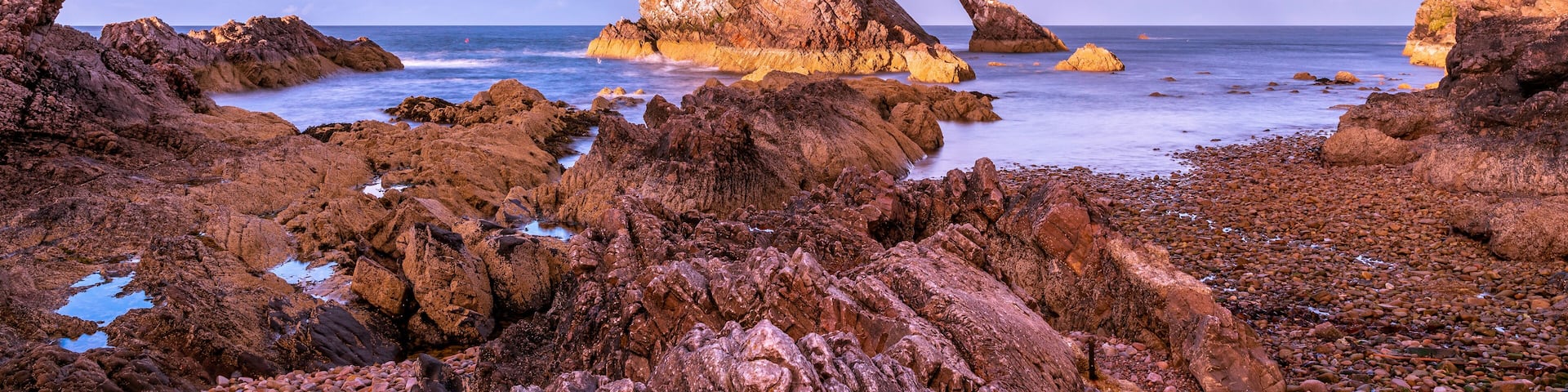 Bow Fiddle Rock during sunset - A natural sea arch near Portknockie on the north-eastern coast of Scotland