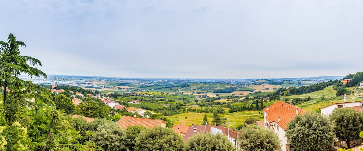 A valley with houses and trees.