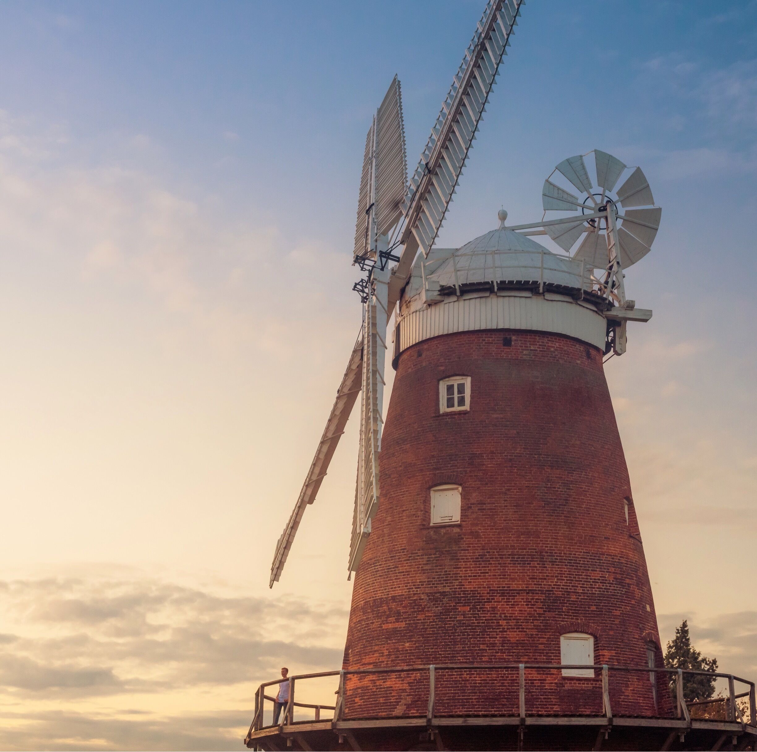 Lovely walk on local public pathway with fantastic views of Windmill known variously as John Webb's Mill or Lowe's Mill.

Thaxted Windmill is a grade II listed tower mill on the edge of the historic hilltop town of Thaxted, about 6 miles south east of Saffron Walden. The mill stands 48 feet high, and is made of red brick, with four wooden sails.

The mill was erected in 1804 on land owned by John Webb, a successful businessman who owned a number of properties locally, including a brick and tile work, and the local Swan Inn. There were 4 other mills in Thaxted at the time, but these were traditional post mills, whereas Webb's Mill was built to a tower design (a post mill rotates the entire body of the structure around a central column, while a tower mill rotates a moveable cap to which the sails are attatched). 

The family of millers who worked the mill were the Lowe family, and so the building is sometimes referred to as Lowe's Mill. Interestingly, one of the recent leaders of the John Webb’s Windmill Trust that runs the mill is a direct descendent of the Lowe family. 

The building material was local brick, fired just half a mile away, and there were 3 sets of millstones. The mill was in operation for just over a century, but by 1907 it was uneconomic to keep open. The advent of efficient steam engines made wind power less appealling and more costly. 

#red #windmill #sunset #uk #britain #england 