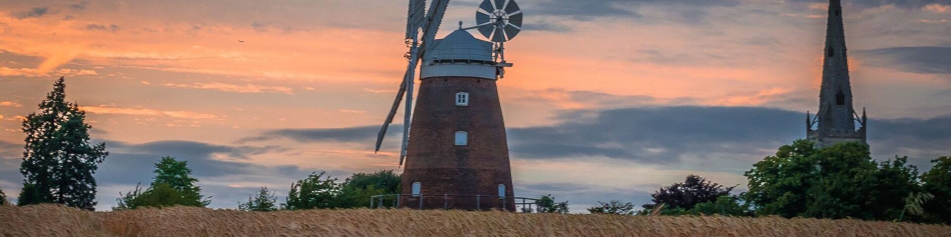 Lovely walk on local public pathway with fantastic views of Windmill known variously as John Webb's Mill or Lowe's Mill.
Thaxted Windmill is a grade II listed tower mill on the edge of the historic hilltop town of Thaxted, about 6 miles south east of Saffron Walden. The mill stands 48 feet high, and is made of red brick, with four wooden sails.
The mill was erected in 1804 on land owned by John Webb, a successful businessman who owned a number of properties locally, including a brick and tile work, and the local Swan Inn. There were 4 other mills in Thaxted at the time, but these were traditional post mills, whereas Webb's Mill was built to a tower design (a post mill rotates the entire body of the structure around a central column, while a tower mill rotates a moveable cap to which the sails are attatched).
The family of millers who worked the mill were the Lowe family, and so the building is sometimes referred to as Lowe's Mill. Interestingly, one of the recent leaders of the John Webb’s Windmill Trust that runs the mill is a direct descendent of the Lowe family.
The building material was local brick, fired just half a mile away, and there were 3 sets of millstones. The mill was in operation for just over a century, but by 1907 it was uneconomic to keep open. The advent of efficient steam engines made wind power less appealling and more costly.
#red #windmill #sunset #uk #britain #england