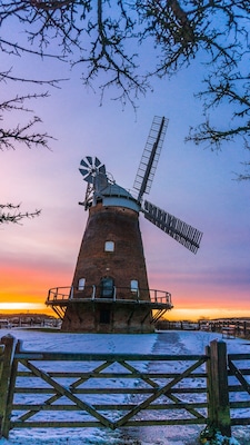 Lovely walk on local public pathway with fantastic views of Windmill known variously as John Webb's Mill or Lowe's Mill.
Thaxted Windmill is a grade II listed tower mill on the edge of the historic hilltop town of Thaxted, about 6 miles south east of Saffron Walden. The mill stands 48 feet high, and is made of red brick, with four wooden sails.
The mill was erected in 1804 on land owned by John Webb, a successful businessman who owned a number of properties locally, including a brick and tile work, and the local Swan Inn. There were 4 other mills in Thaxted at the time, but these were traditional post mills, whereas Webb's Mill was built to a tower design (a post mill rotates the entire body of the structure around a central column, while a tower mill rotates a moveable cap to which the sails are attatched).
The family of millers who worked the mill were the Lowe family, and so the building is sometimes referred to as Lowe's Mill. Interestingly, one of the recent leaders of the John Webb’s Windmill Trust that runs the mill is a direct descendent of the Lowe family.
The building material was local brick, fired just half a mile away, and there were 3 sets of millstones. The mill was in operation for just over a century, but by 1907 it was uneconomic to keep open. The advent of efficient steam engines made wind power less appealling and more costly.
#red #windmill #sunset #uk #britain #england #eastanglia #colours #history #perspectives