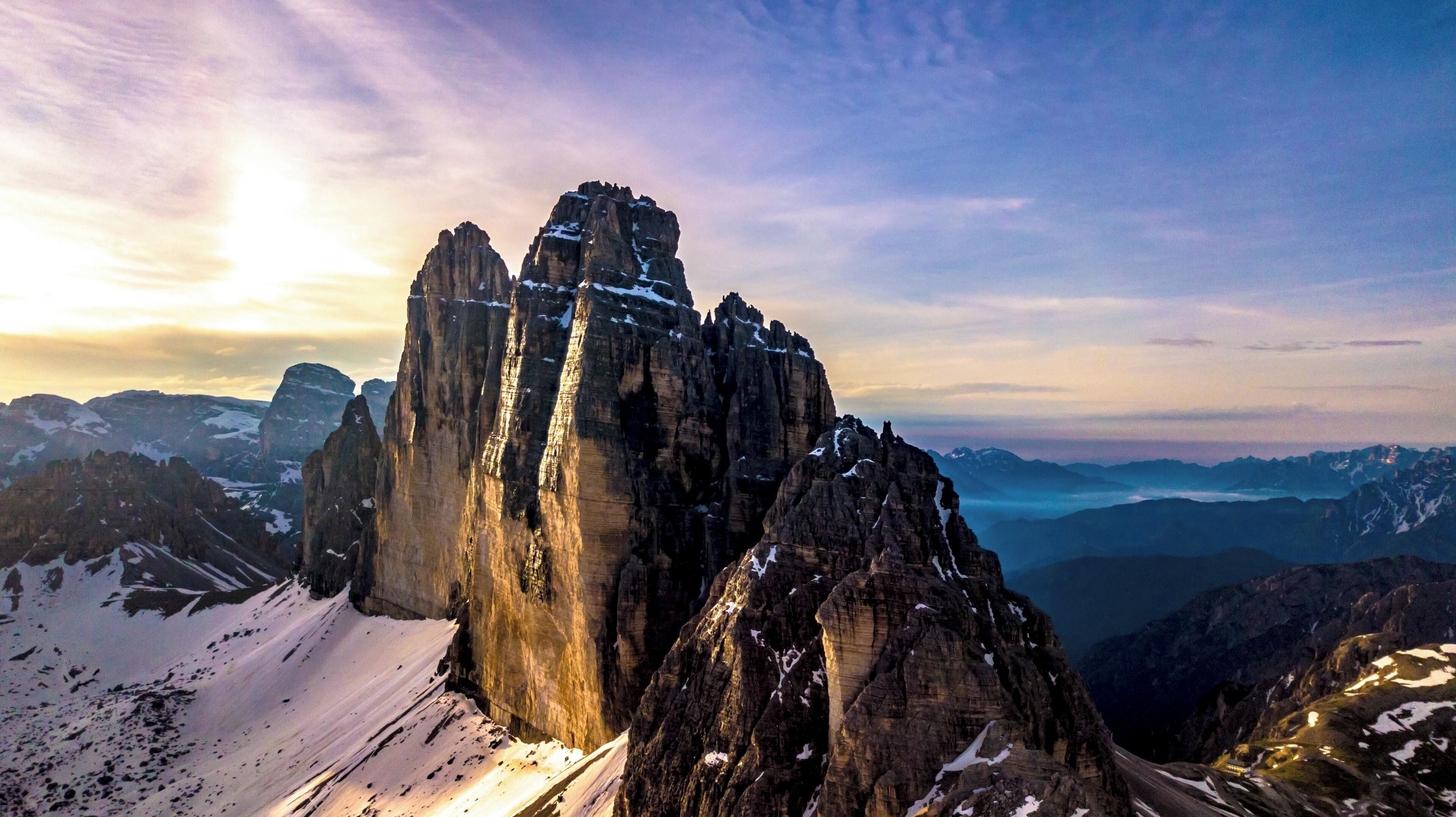 A mountain range with prominent rock formations and snow-covered peaks.