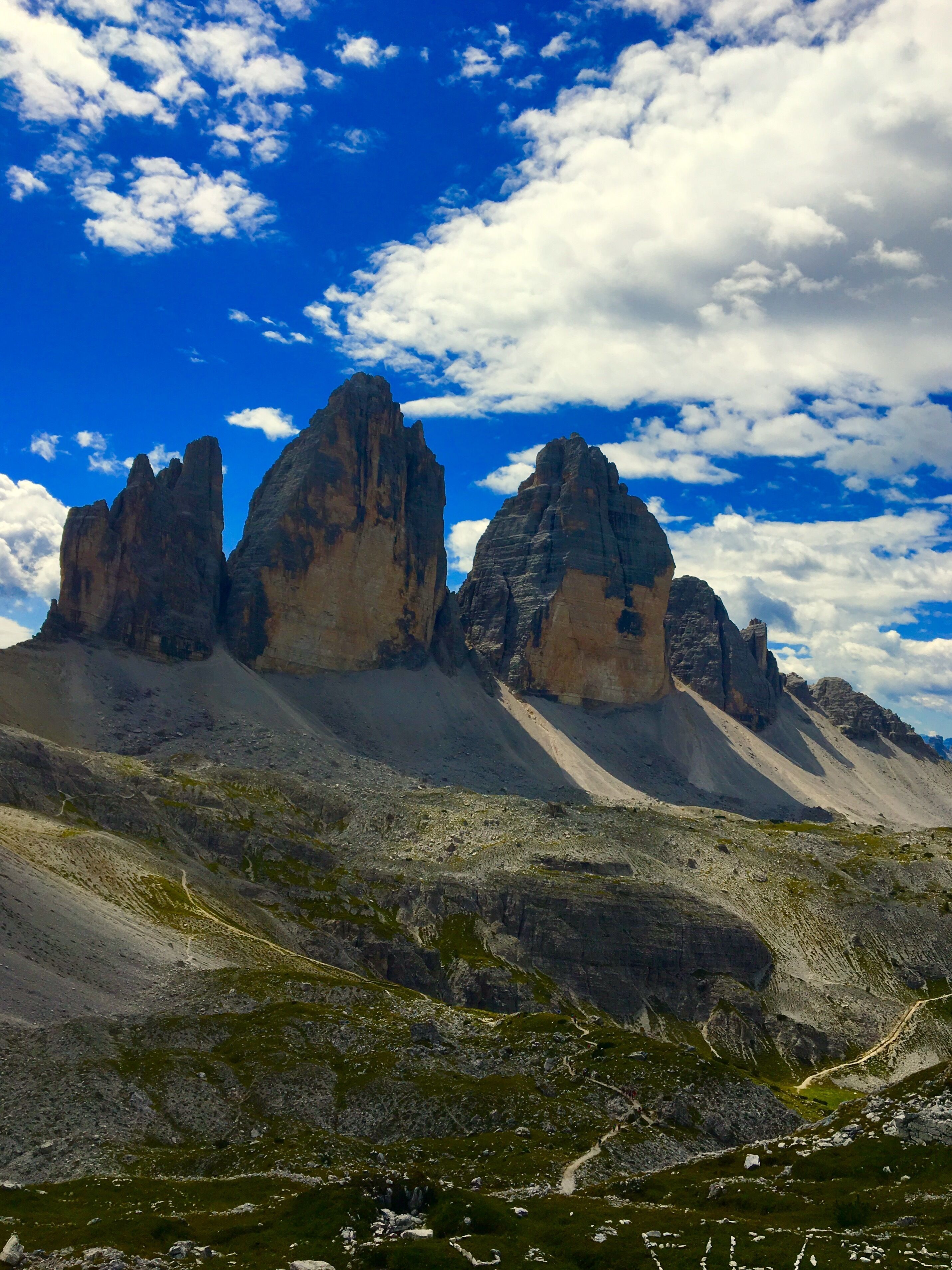 A mountainous landscape with prominent rock formations under a partly cloudy sky.