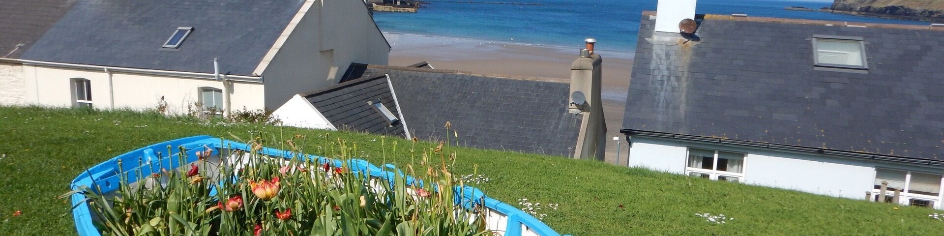 The view of the beach between the houses