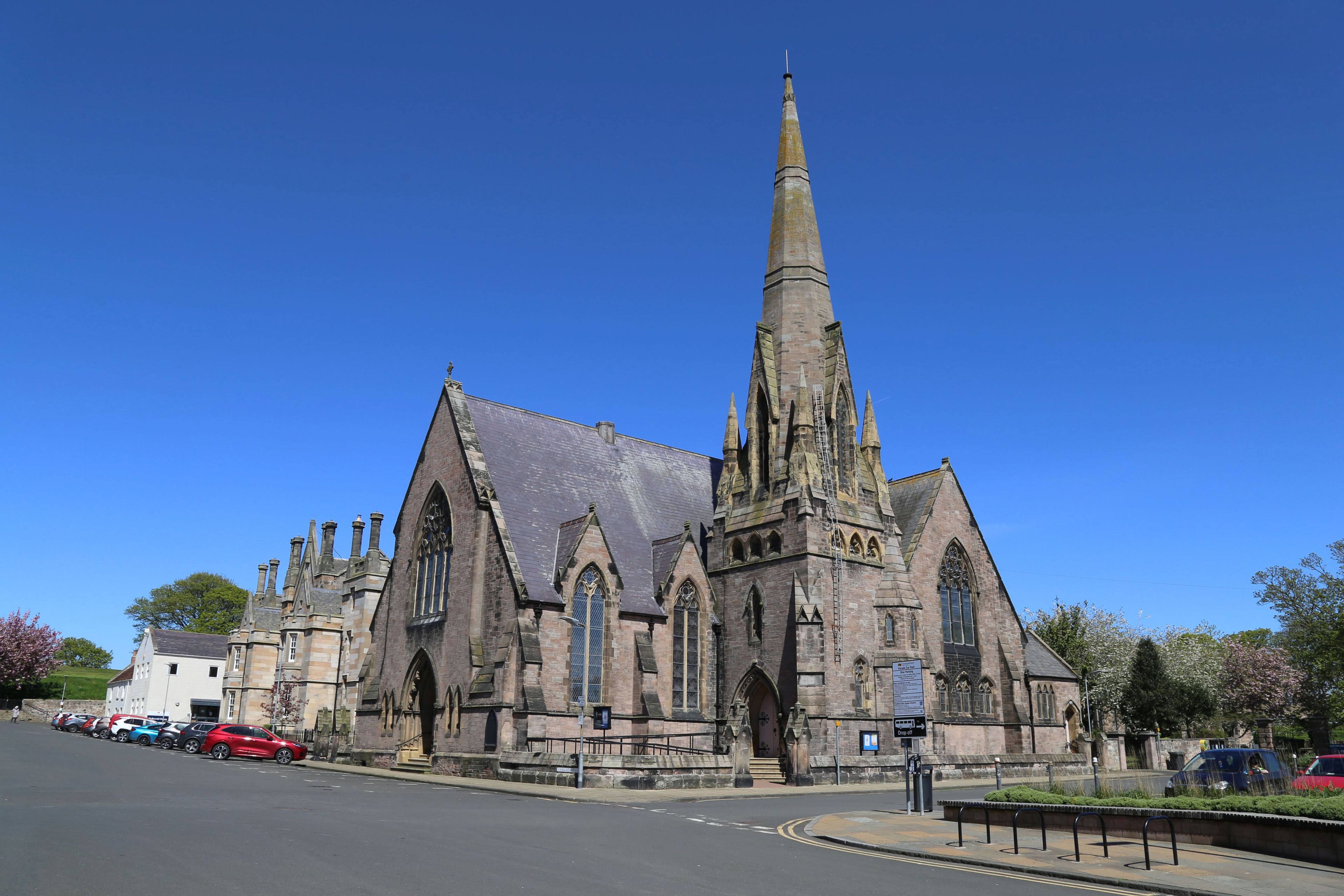 A historic church with a tall spire and Gothic architecture.
