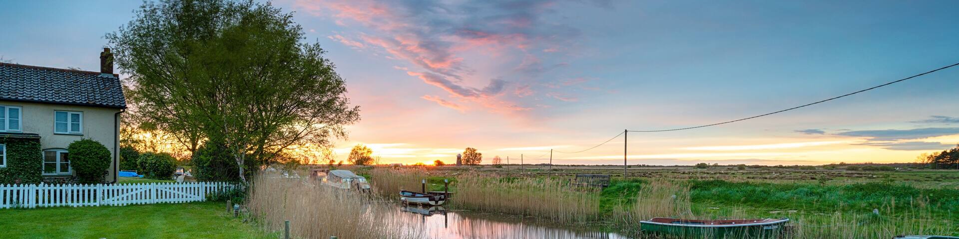 Sunset over boats on the river at West Somerton