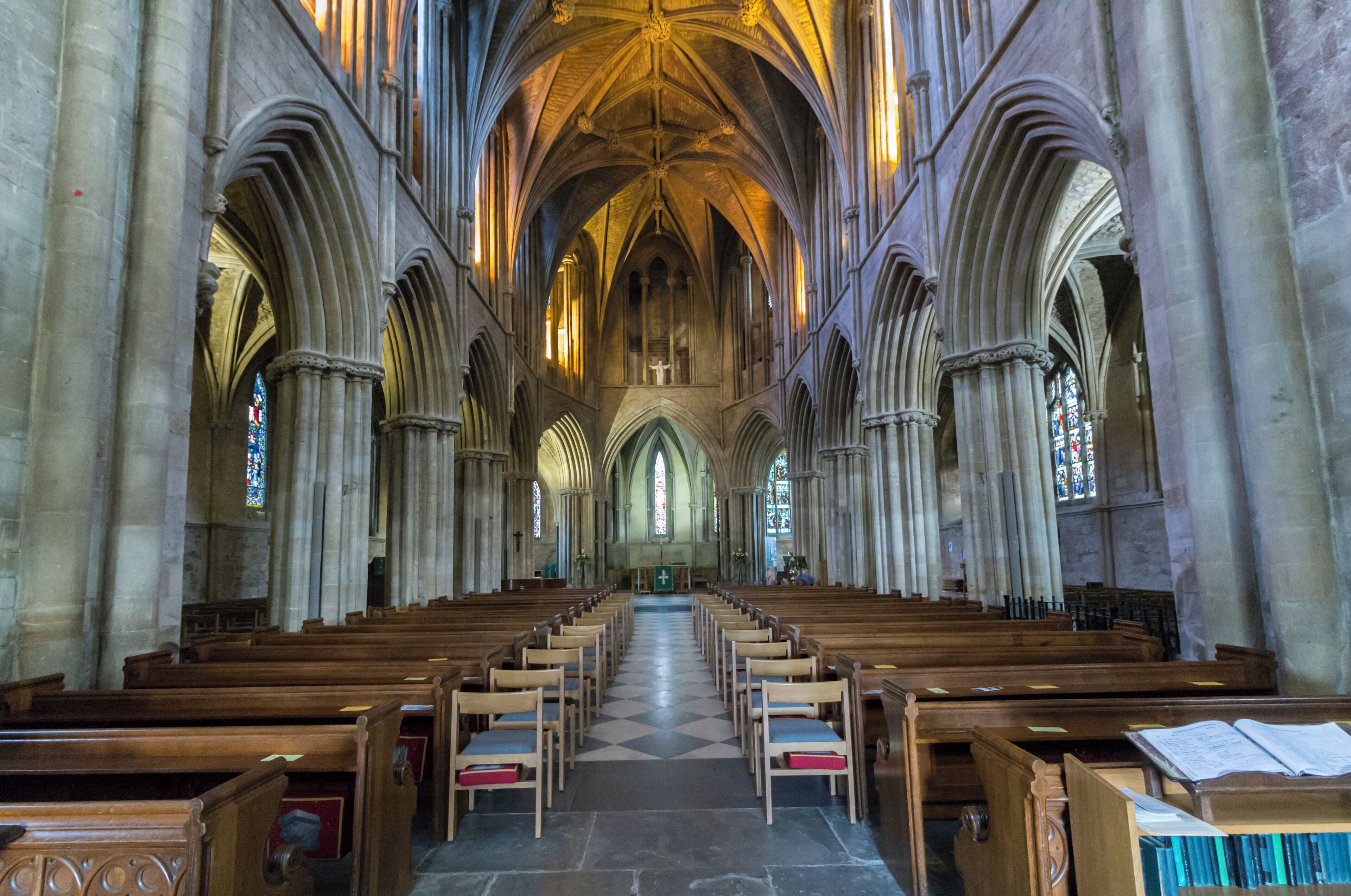 The existing Abbey is the remains of a larger building, and it is believed there was church here as long ago as 689 A.D. In the south quire aisle floor there is an exposed area of foundation of the Saxon church. The current building probably dates from around 1090 onwards. In 1288 there was a fire which caused much damage, and the chancel was rebuilt shortly afterwards. The Abbey was dissolved in 1539 and the nave was pulled down. The north transept collapsed in the 17th century and the crossing tower was shored up on that side. There were further alterations in the 19th century when the eastern apse was built. The south transept contains the oldest work, and there was once a cloisters and Monk's lodgings to the south. The Abbey now consists of north and south transepts, crossing tower, chancel with quire aisles and eastern apse. There are chapels to the north east and the south east. Nothing of the original nave remains except the two eastern piers which are incorporated into butressing. The crossing tower dates from the early 14th century. The large buttresses were added in 1913 when cracking was found. The tower is of four stages with four octagonal pinnacles with crockets. The former roof lines can be seen on the sides of the tower. Inside, an unusual bellringing platform high above the ground was inserted by Sir George Gilbert Scott in the 19th century. The chancel is of four bays with piers dating from the early 13th century. Above this are clerestory windows with the ceiling having vaulting and fine roof bosses dating from the late 13th century. There are several effigies and monuments in the Abbey, including a cross-legged Knight from the 13th century. The font is Norman and was restored in 1921. It depicts Christ and the Apostles under intersecting arches. The south-east chapel has mediaeval floor tiles. There are several stained-glass windows by various makers including Kempe. Pic by Jenny.