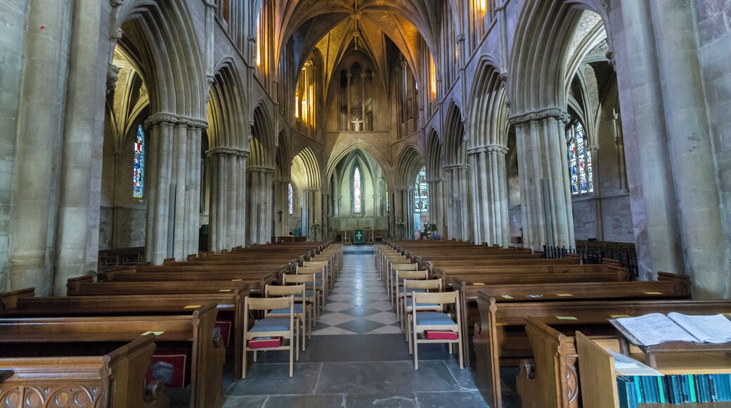 The existing Abbey is the remains of a larger building, and it is believed there was church here as long ago as 689 A.D. In the south quire aisle floor there is an exposed area of foundation of the Saxon church. The current building probably dates from around 1090 onwards. In 1288 there was a fire which caused much damage, and the chancel was rebuilt shortly afterwards. The Abbey was dissolved in 1539 and the nave was pulled down. The north transept collapsed in the 17th century and the crossing tower was shored up on that side. There were further alterations in the 19th century when the eastern apse was built. The south transept contains the oldest work, and there was once a cloisters and Monk's lodgings to the south. The Abbey now consists of north and south transepts, crossing tower, chancel with quire aisles and eastern apse. There are chapels to the north east and the south east. Nothing of the original nave remains except the two eastern piers which are incorporated into butressing. The crossing tower dates from the early 14th century. The large buttresses were added in 1913 when cracking was found. The tower is of four stages with four octagonal pinnacles with crockets. The former roof lines can be seen on the sides of the tower. Inside, an unusual bellringing platform high above the ground was inserted by Sir George Gilbert Scott in the 19th century. The chancel is of four bays with piers dating from the early 13th century. Above this are clerestory windows with the ceiling having vaulting and fine roof bosses dating from the late 13th century. There are several effigies and monuments in the Abbey, including a cross-legged Knight from the 13th century. The font is Norman and was restored in 1921. It depicts Christ and the Apostles under intersecting arches. The south-east chapel has mediaeval floor tiles. There are several stained-glass windows by various makers including Kempe. Pic by Jenny.