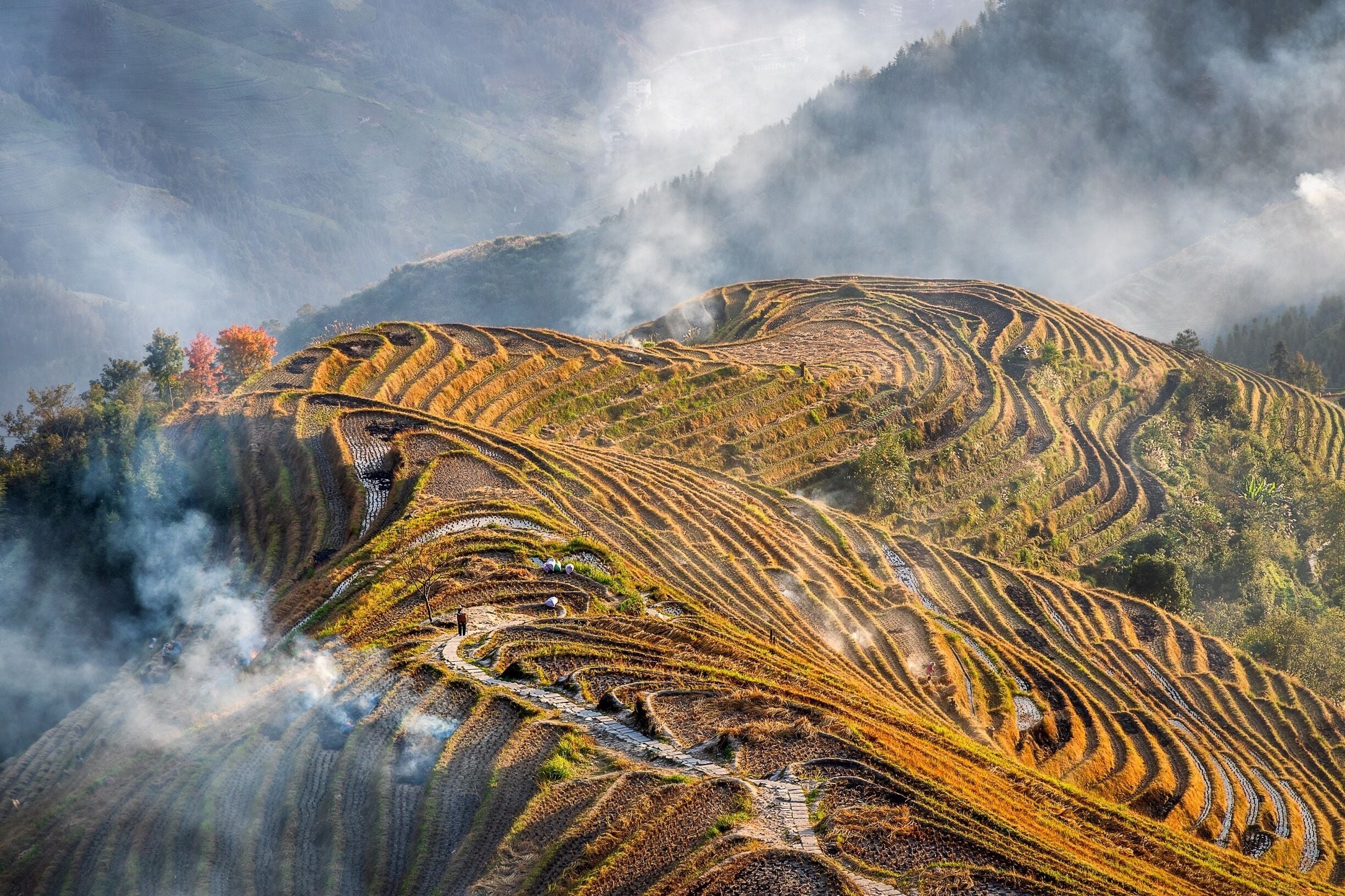 When the harvest is done it’s time to prepare for winter.  Any of the rice hay not required for animal feed is burned in the terraces.  Climb to the top of the village and beyond to a great scenic spot for sunset and just gaze as the villagers set about their daily tasks.  Such a great view at any time but aim to get their for sunrise or sunset for the best light on the valleys and terraces.  You can visit all year round, but for the best reflections in the rice terraces aim to be here in April or May when they irrigate the fields.