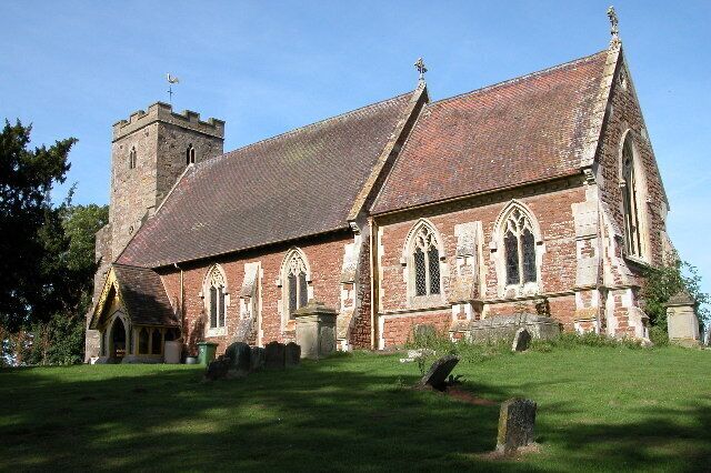 A historic church with a prominent tower and arched windows.
