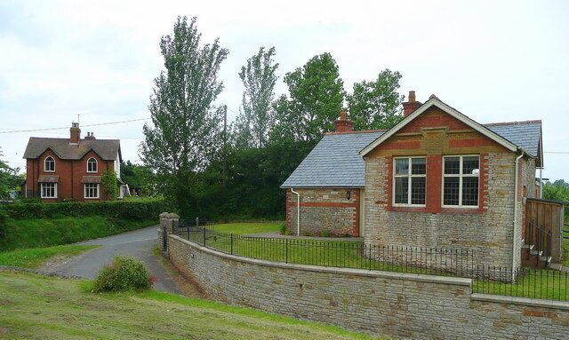 Two Victorian Buildings? The cottages to the left certainly are; the building on the right, which is currently the village hall, used to be a school and has inscribed the date in Roman numerals MCMV, 1905, as well as Vicar's School Founded 1842. So the gable end facing the camera could have been an later extension.