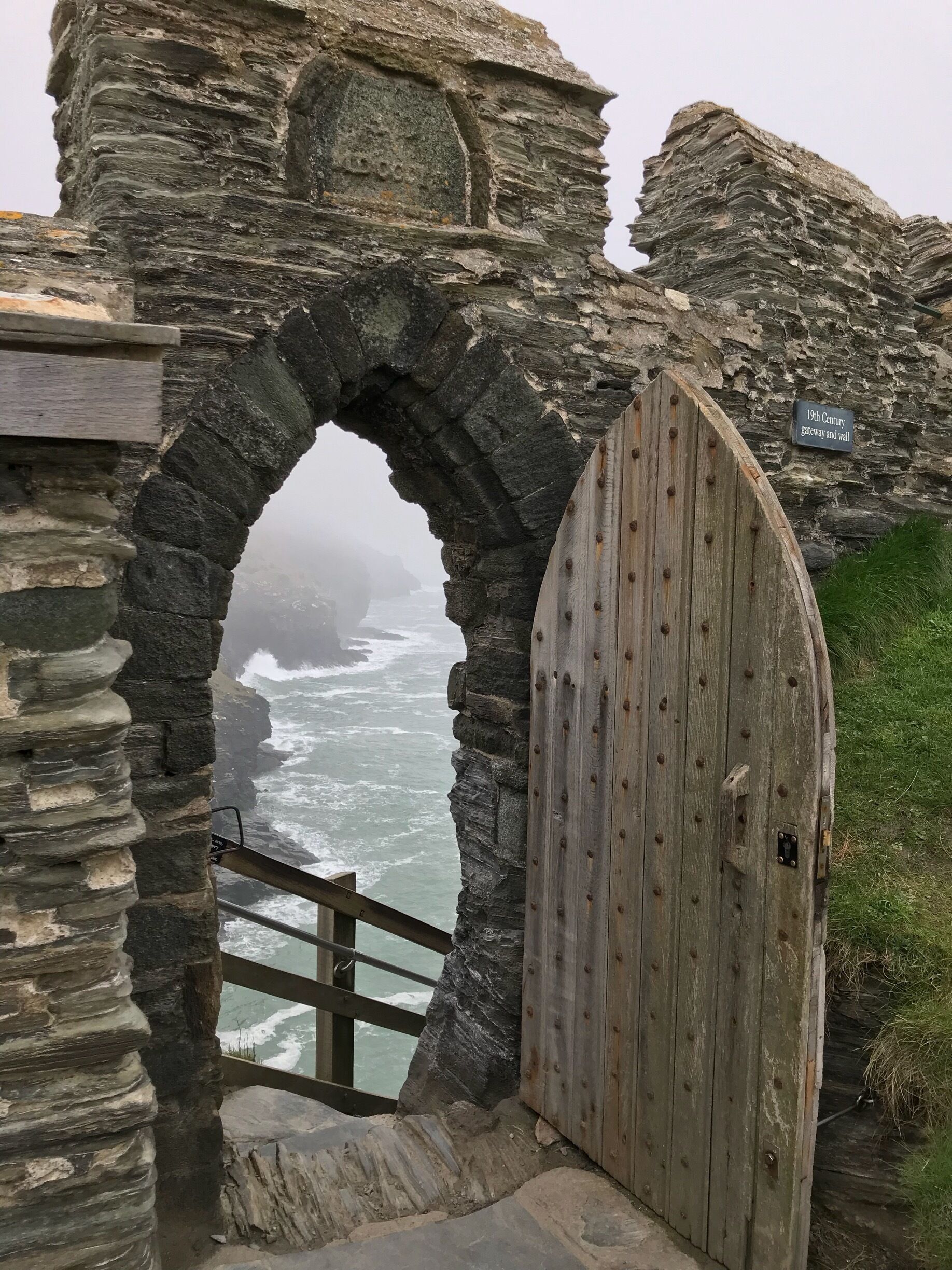 Old door of Tintagel Castle leading to some very steep steps. A little easier on the way down.