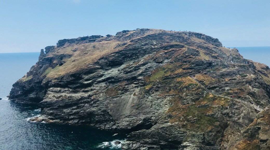 Tintagel Castle is a medieval fortification located in North Cornwall. Visitors like myself flock to see Tintagel Castle as it has a long association with legends related to King Arthur. The long walk down & up the castle cliffs is worth the amazing views. In the height of summer itâs packed with people so be prepared for queues and bring a bottle of water as you break a sweat during the trek up and down Tintagel.