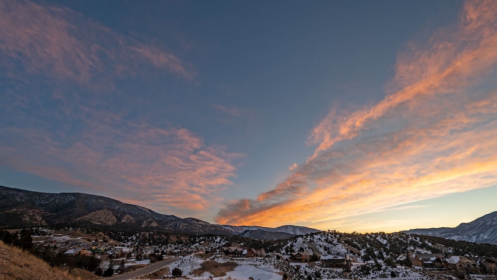 Colorful orange and blue winter sunrise cloudscape over New Castle in western Colorado.