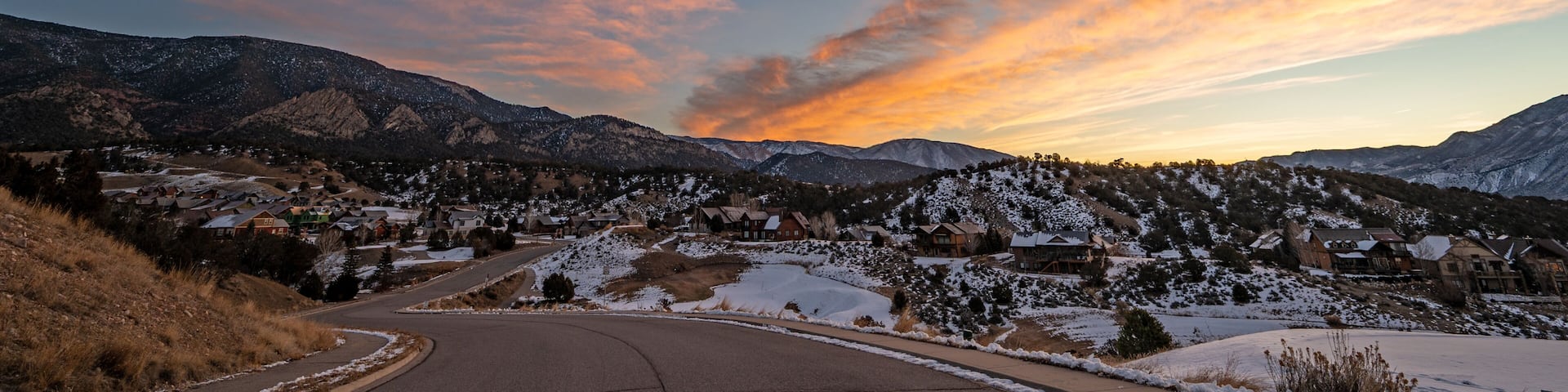 Colorful orange and blue winter sunrise cloudscape over New Castle in western Colorado.