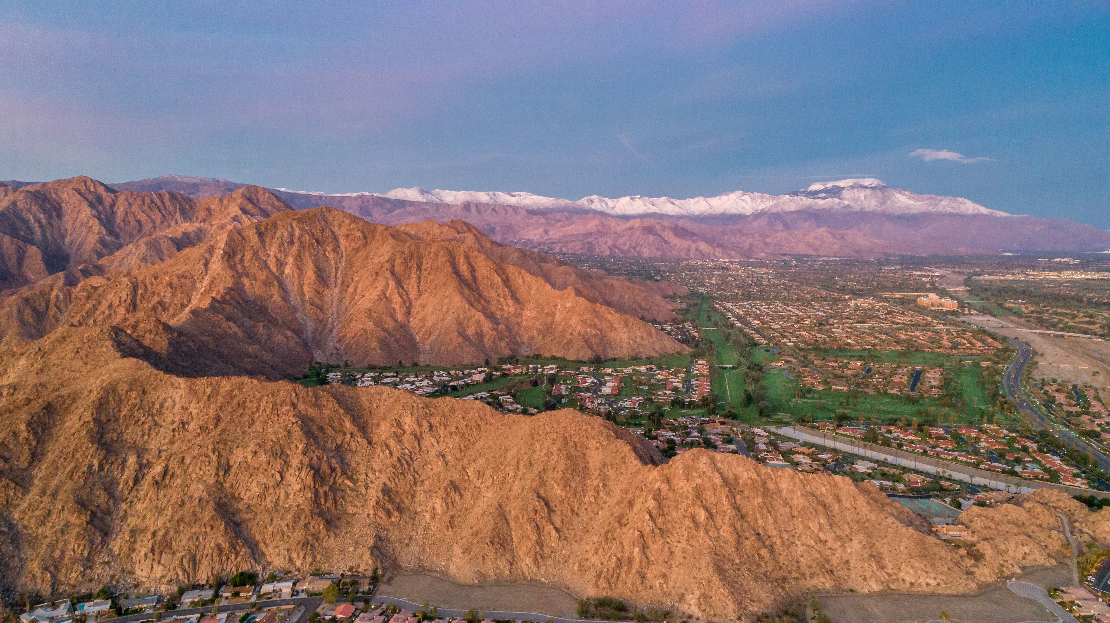 A mountainous landscape with a town nestled at its base.