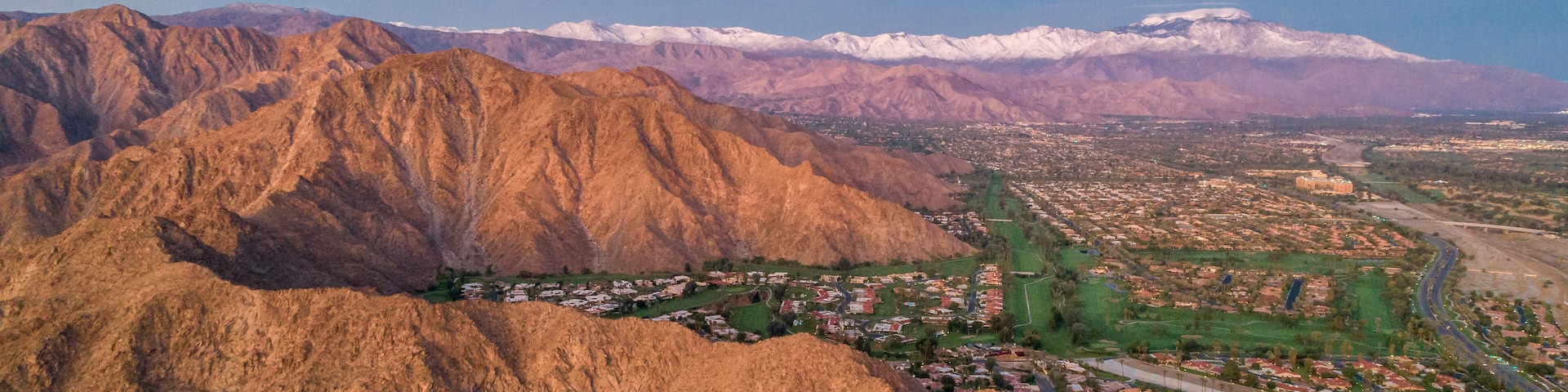A mountainous landscape with a town nestled at its base.