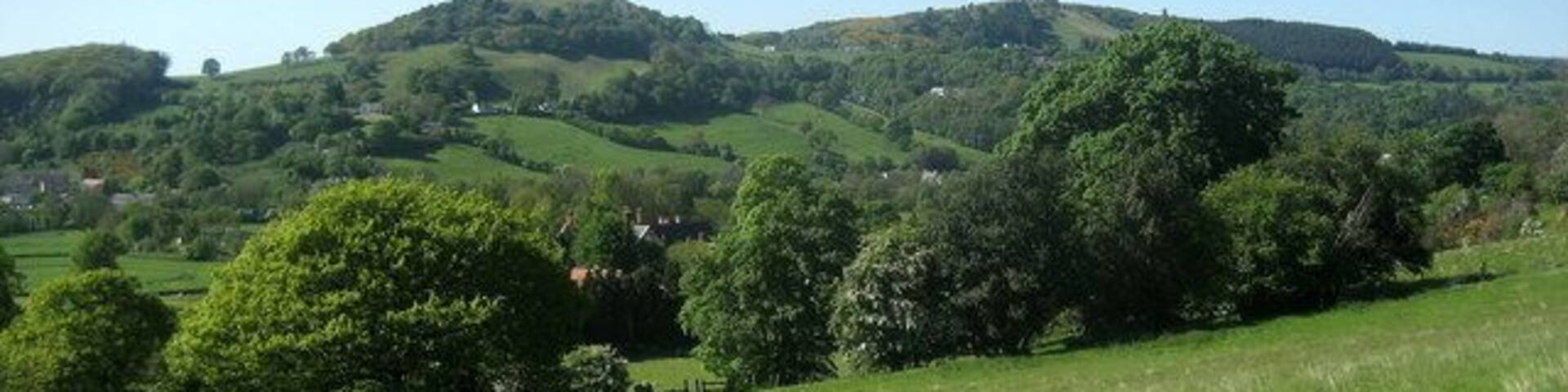 Offa's Dyke Path in the Wheeler Valley Approaching Grove Hall as the trail crosses the Wheeler Valley before the ascent of Moel y Gaer - the hill seen ahead.